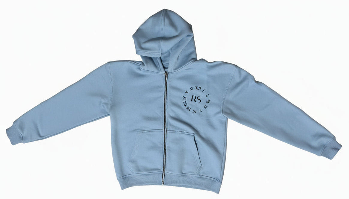 Light blue hoodie with a logo on a concrete floor