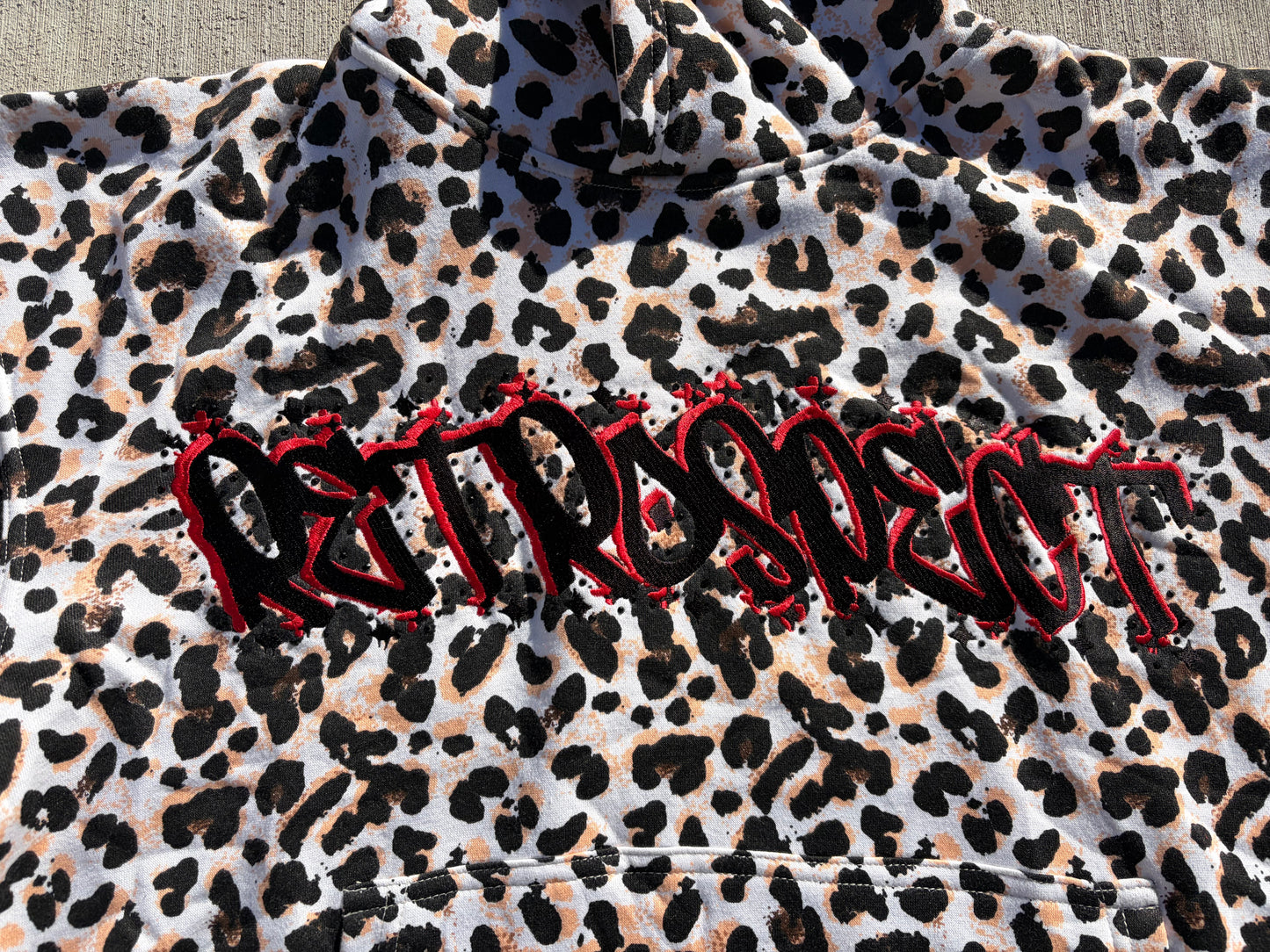 White Retrospect Bejeweled Cheetah Print Hoodie with front view, featuring sparkling embellishments and a cozy fit.