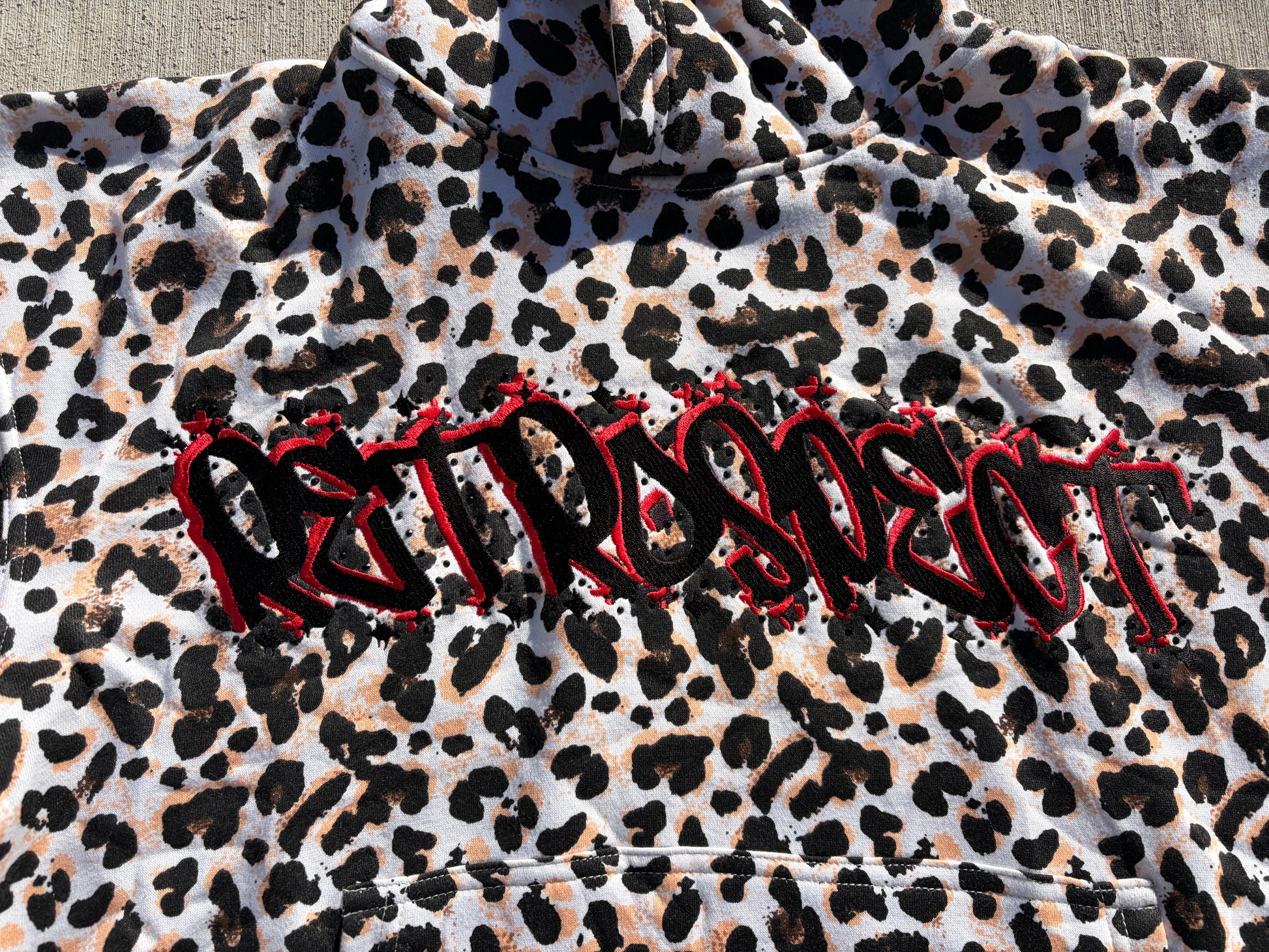 White Retrospect Bejeweled Cheetah Print Hoodie with front view, featuring sparkling embellishments and a cozy fit.